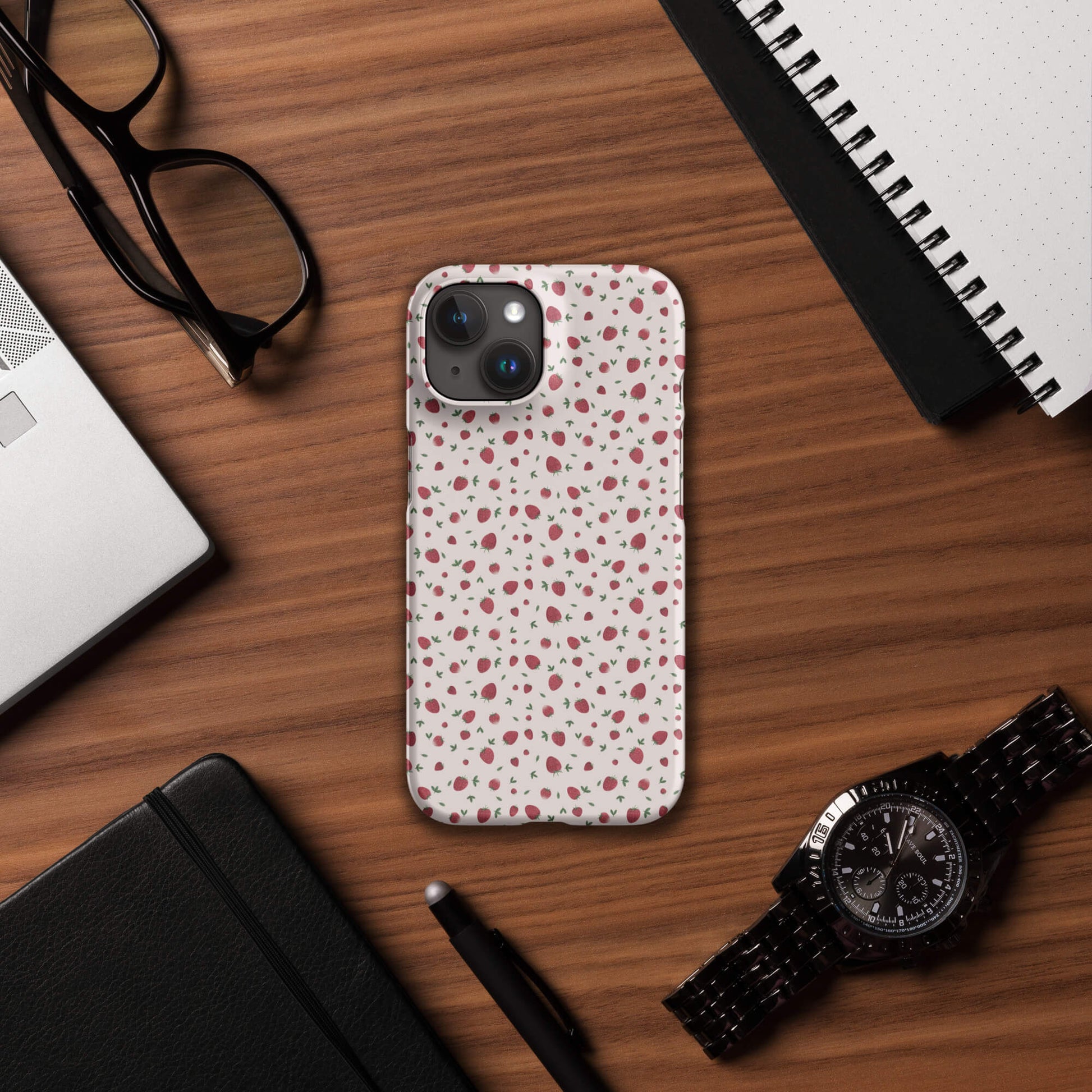 Strawberry pink iPhone case on desk with accessories, mockup