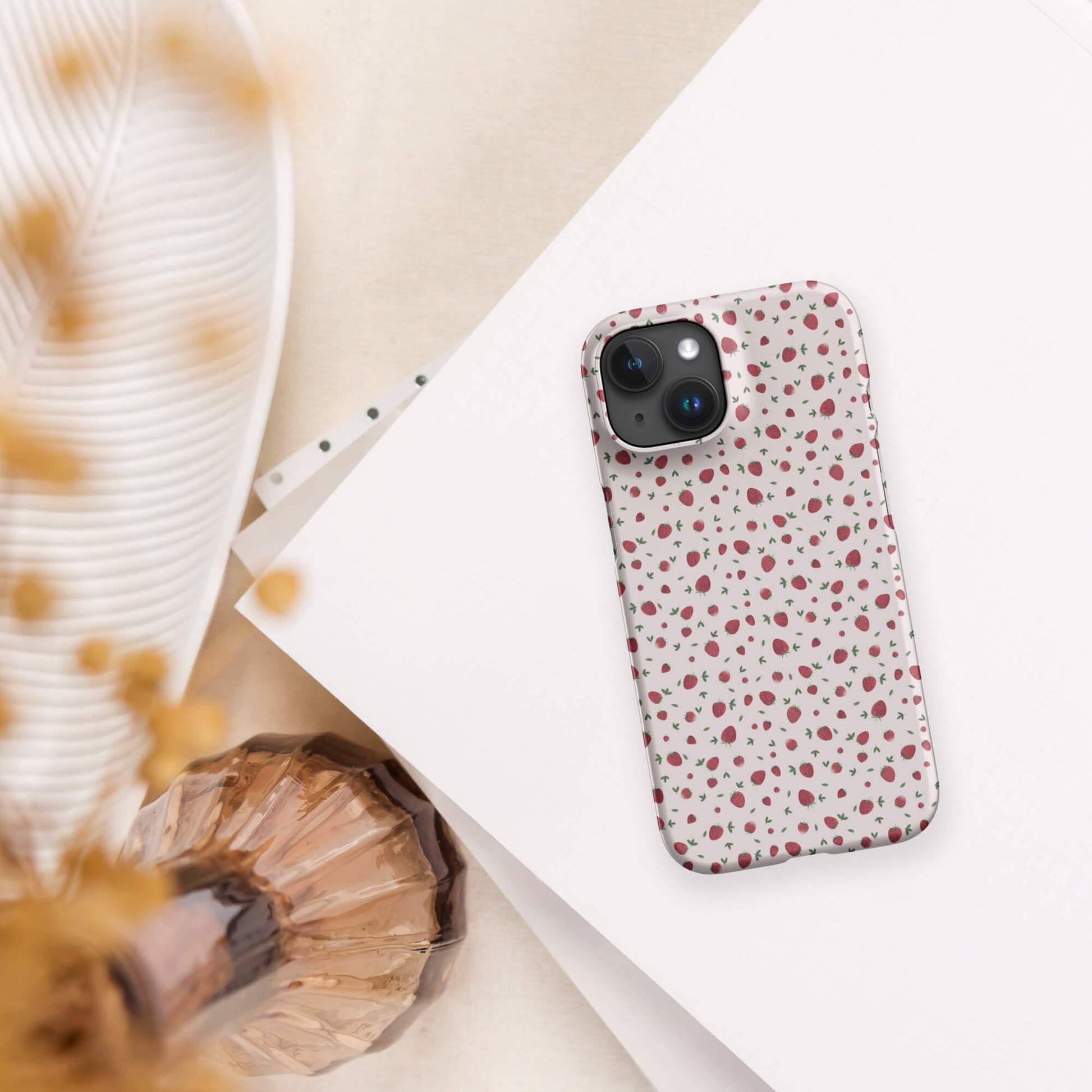 Strawberry pink iPhone case mockup on paper with lampshade